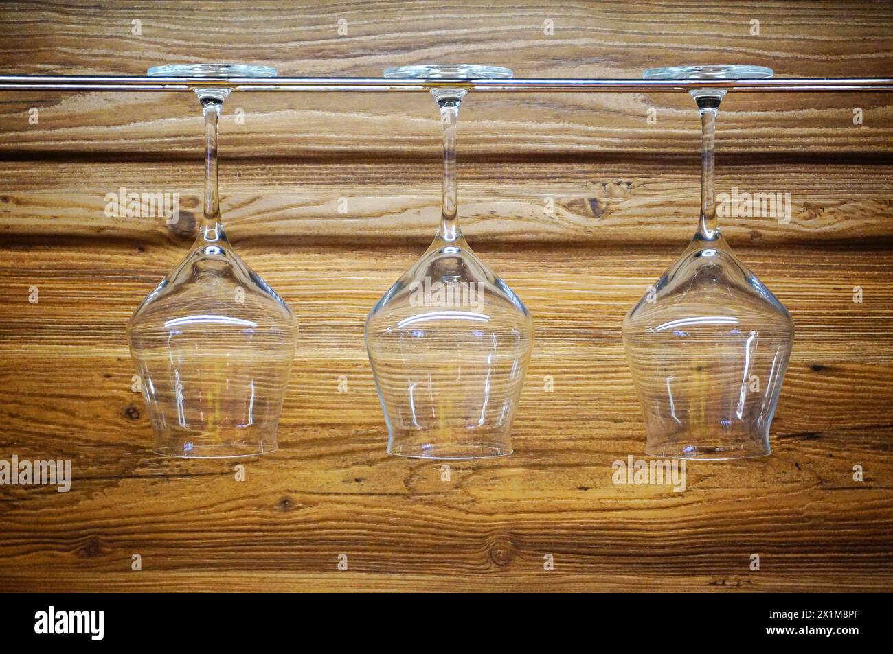 Wine glasses hanging on the counter in the kitchen Stock Photo