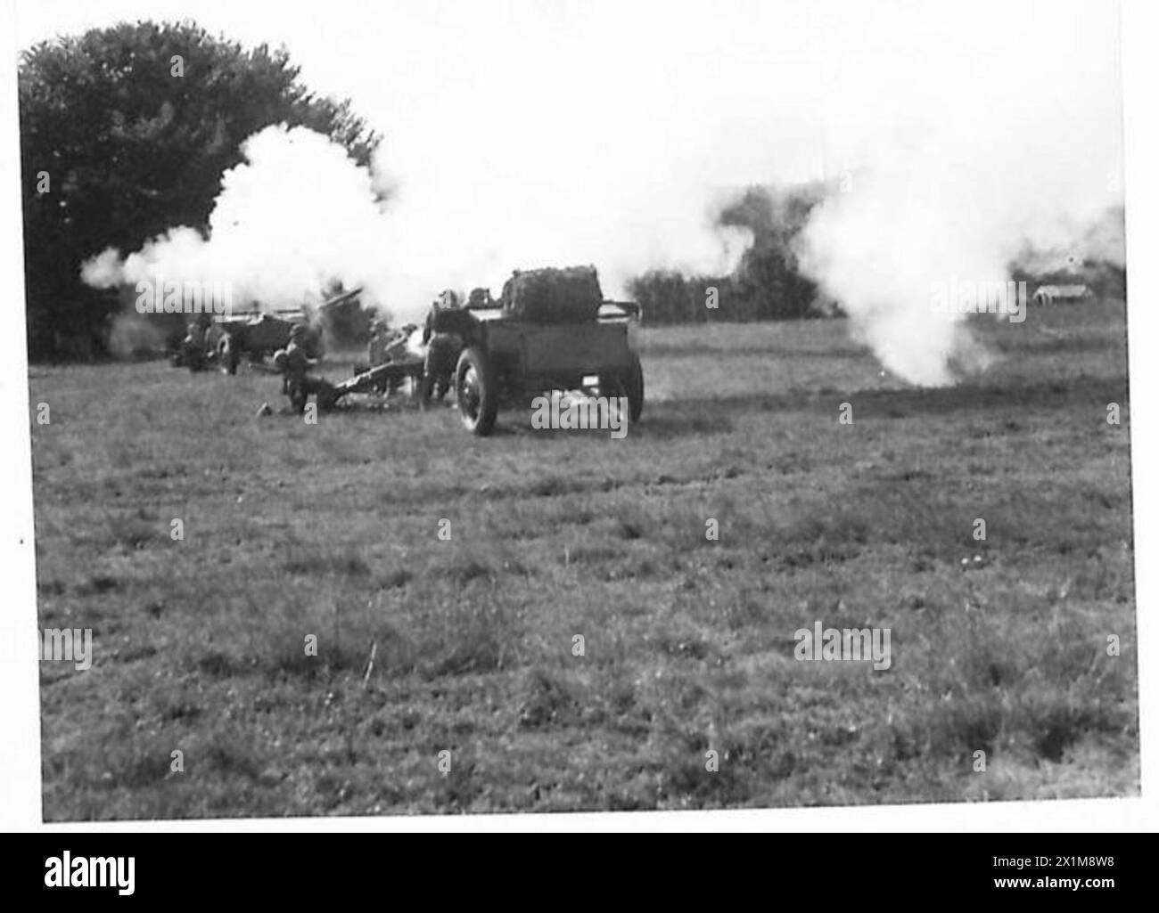 MILITARY DISPLAY FOR FACTORY WORKERS - A 25-pounder gun firing during
