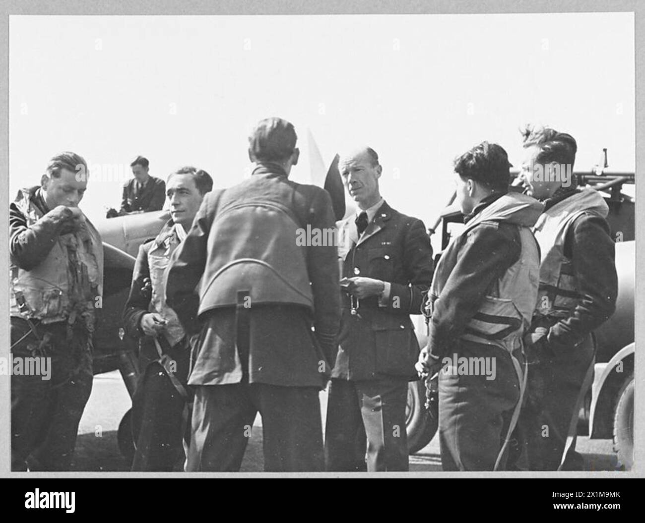 Refulled Photograph showing RAF Fighter Command pilots being interrogated by an ...