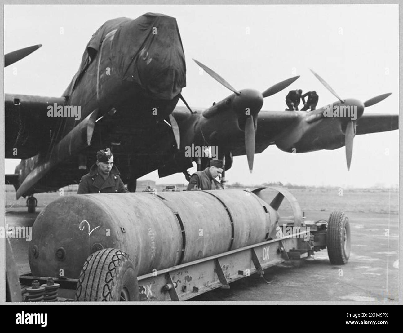 R.A.F's 12,000 LB. BOMB : - 12450 Picture (issued 1944) shows - Preparing to load a 12,000 lb. bomb on to a waiting Lancaster, Royal Air Force Stock Photo