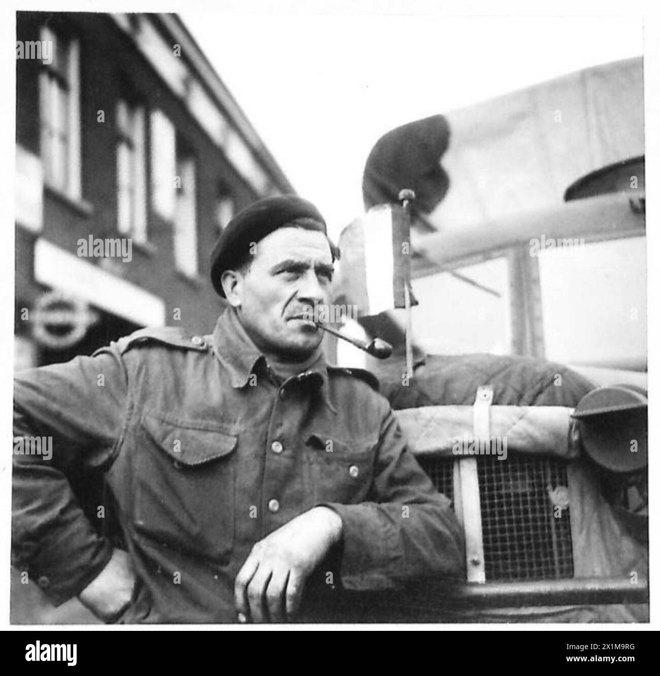 FEEDING LIBERATED HOLLAND - All transport for thks depot, which has operated throughout Belgium and France, has been done by a French Transport Column, who joined depot in September and driven nothing else but food ever since. Pictures shows Adrien Goguesnoy of Paris, a typical driver with the column standing beside his lorry from which he flies his National flag, British Army, 21st Army Group Stock Photo