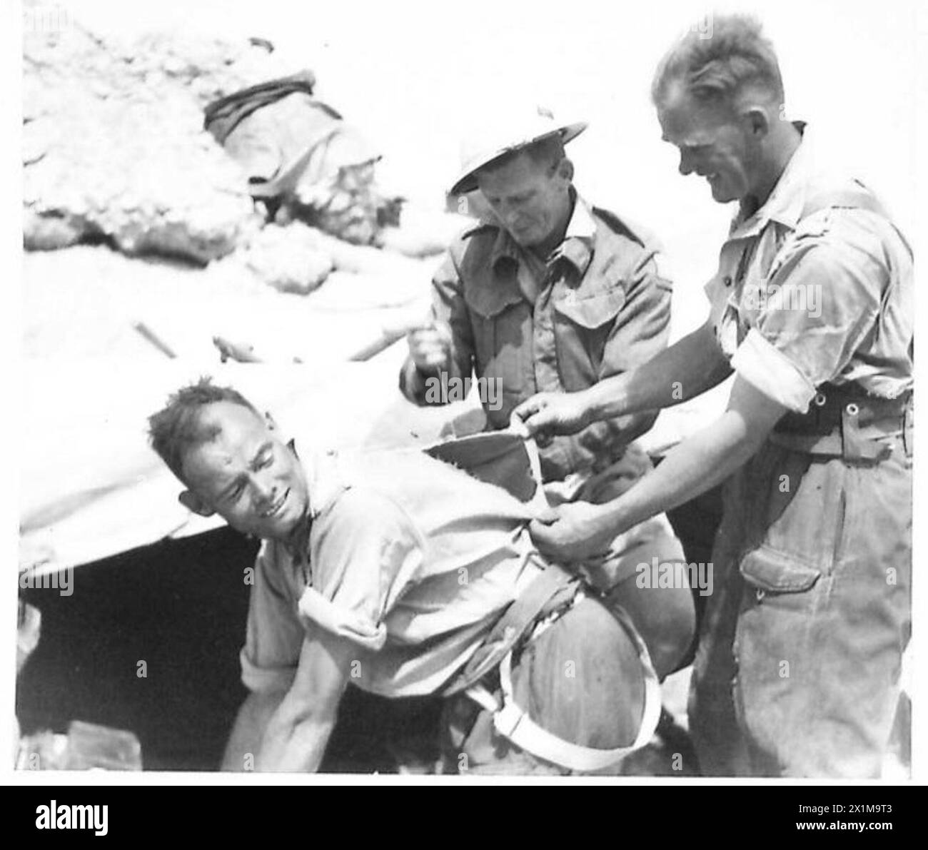 Eighth Army Inprocessing A corporal cook of the Eighth Army in the Mareth area has his shirt ...