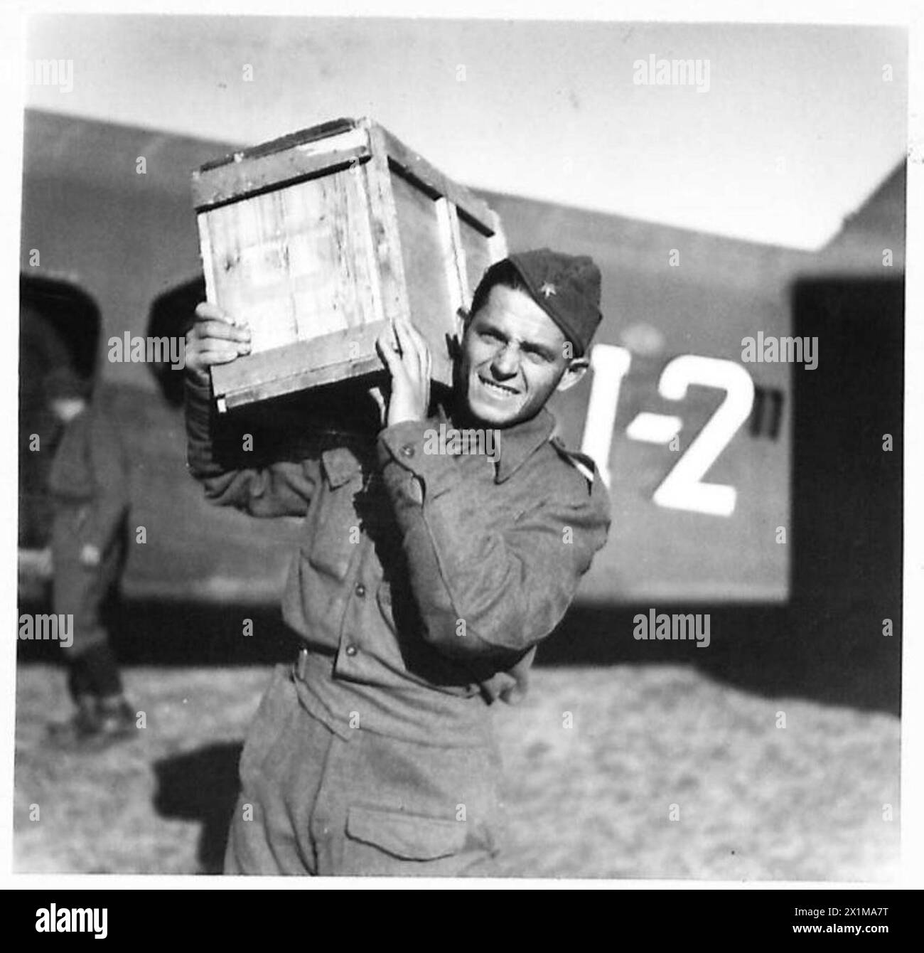 Partisan troops unload transport planes carrying compo rations, Bren ...