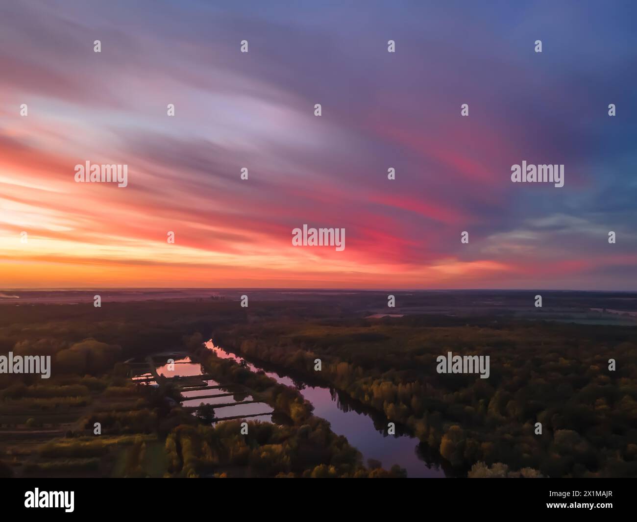 Aerial view of beautiful river and forest landscape with colorful summer skySunset along the banks of the river. Stock Photo