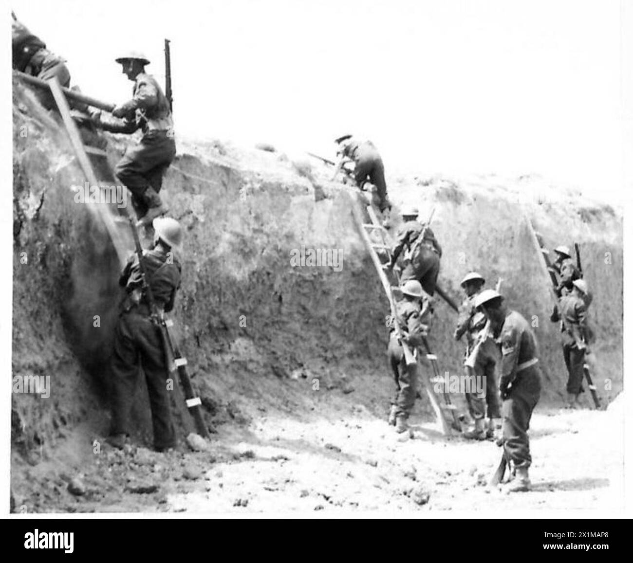 British troops of the Eighth Army use scaling ladders to navigate the Wadi Zigzoua, a key defensive feature of the Mareth line, during re-enactment training. Stock Photo