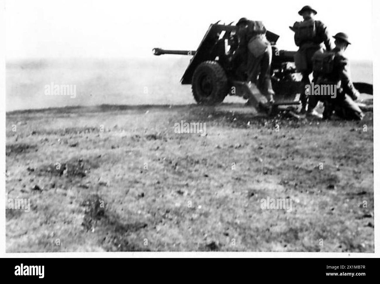DEMONSTRATION OF 17-POUNDER GUN TO FACTORY WORKERS - The 17-pounder gun firing at a moving tank on the range, British Army Stock Photo