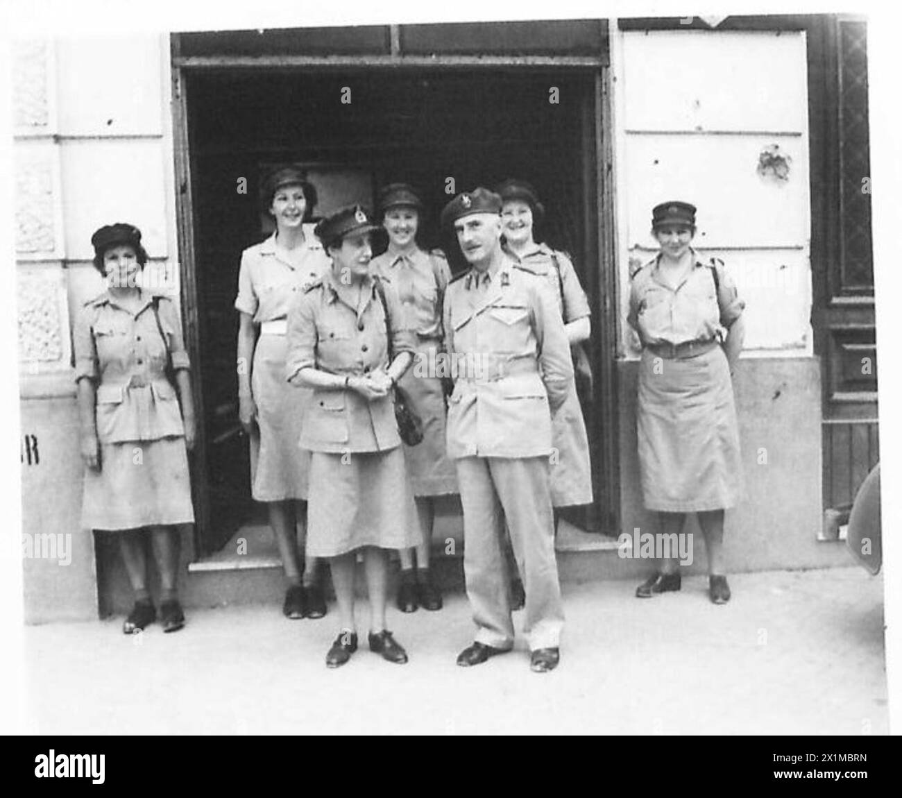 CHIEF OF THE A.T.S. IN ITALY - Mrs. Whateley and Brigadier Woods during their tour of Roberts Barracks. Behind, left to right, are:- S.Condr.B.L. Smith; Sub. J. Lander; Jnr.Comdr. V. Stride, Jnr.Comdr.Menzieas and Snr.Comdr. M.B. Baker, British Army Stock Photo