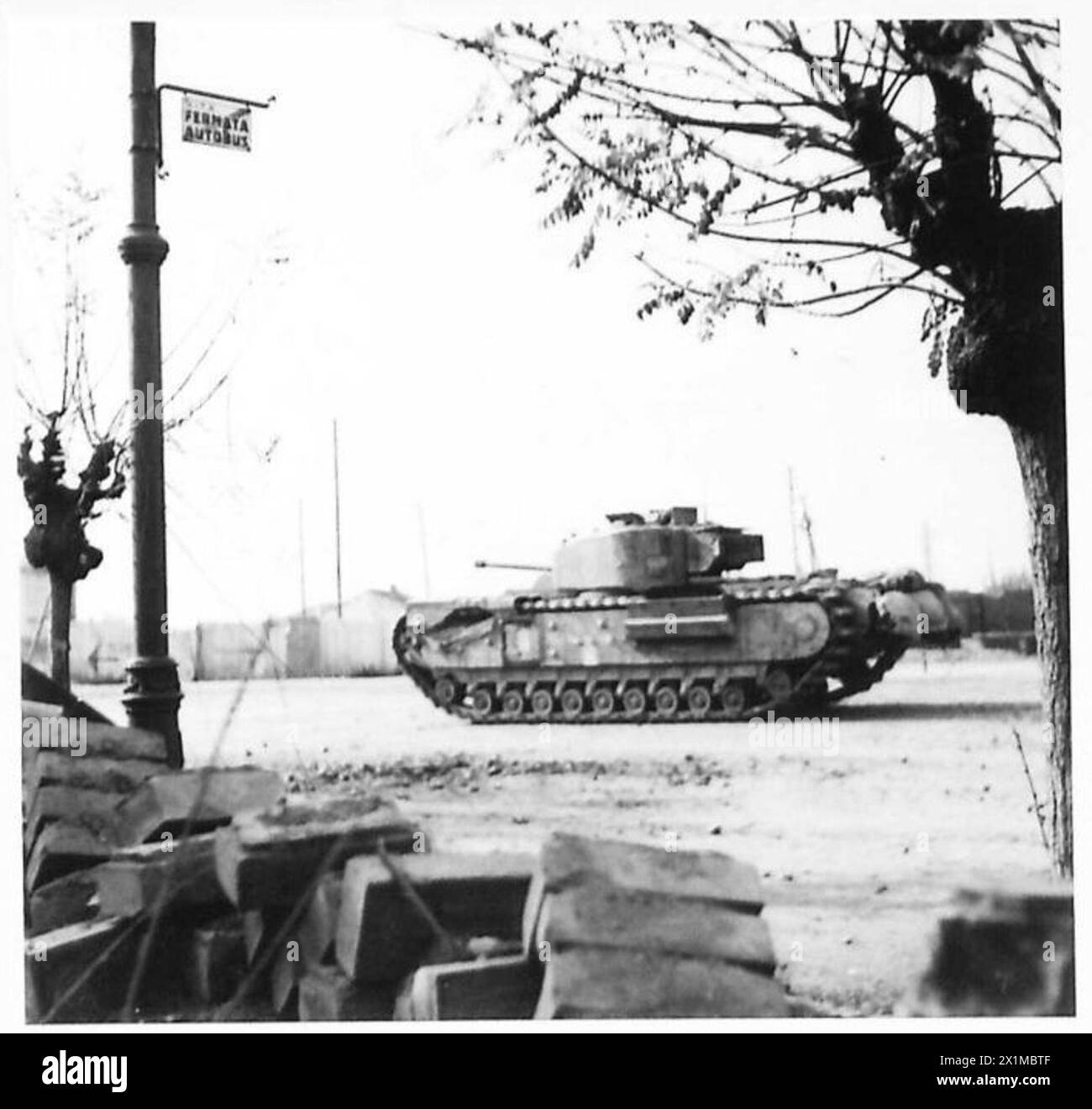 A Churchill tank of the Eighth Army approaches the road junction at the ...