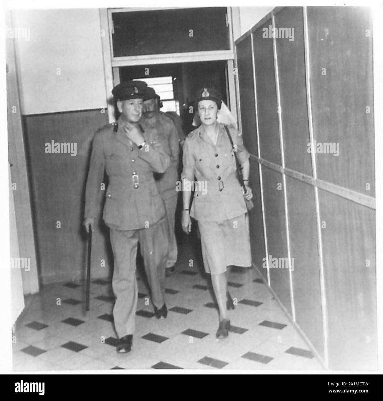 CHIEF OF THE A.T.S. IN ITALY - Mrs. Whateley leaves the hospital with Colonel W.J.F. Craig, OBE and C.O. of the hospital, British Army Stock Photo
