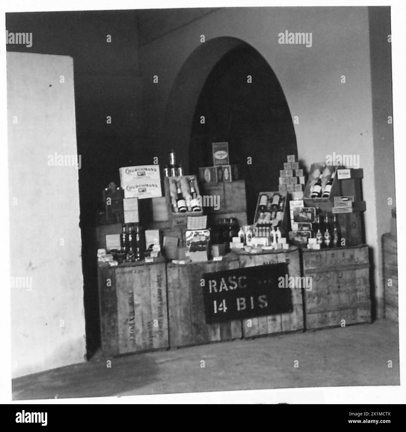 NAAFI SUPPLIES FOR FRONT LINE UNITS - No shop windows to dress on Active Service - but this is just as good, buyers can complete their orders from this show, British Army Stock Photo