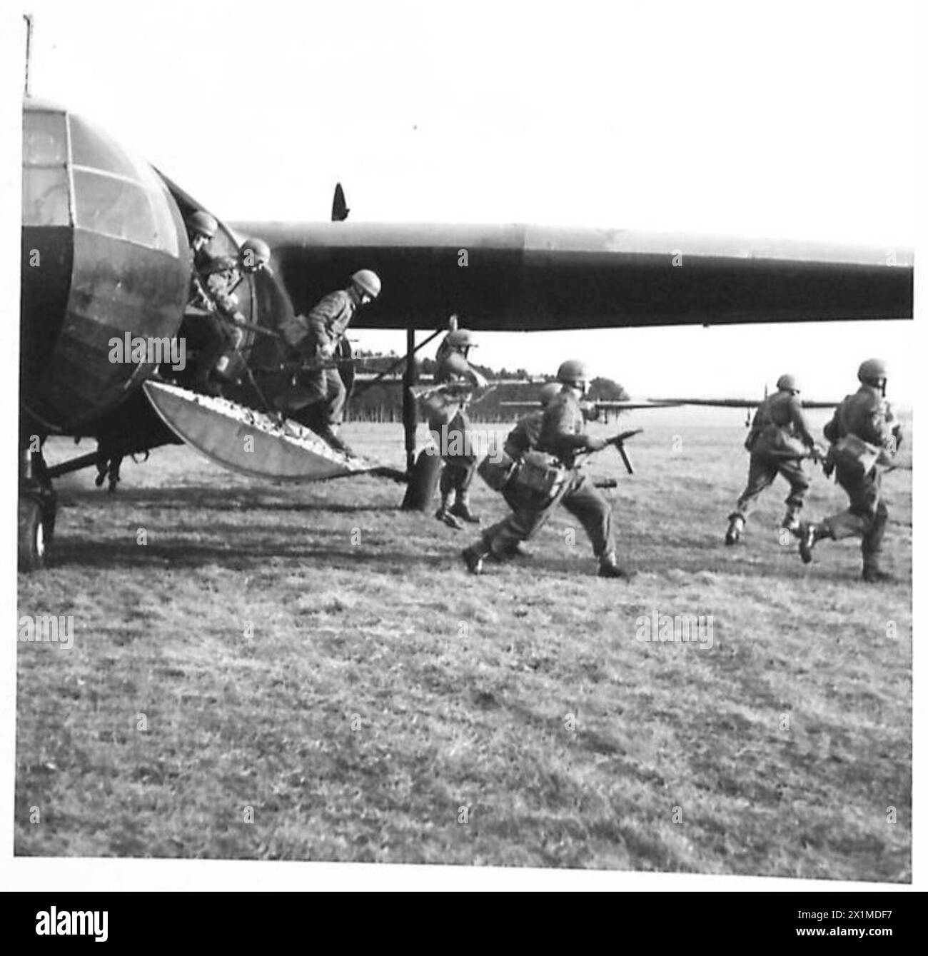 BRITISH GLIDER TROOPS IN TRAINING - Glider troops de-plane from a Horsa glider and carry out their training drill of going into action immediately, British Army Stock Photo