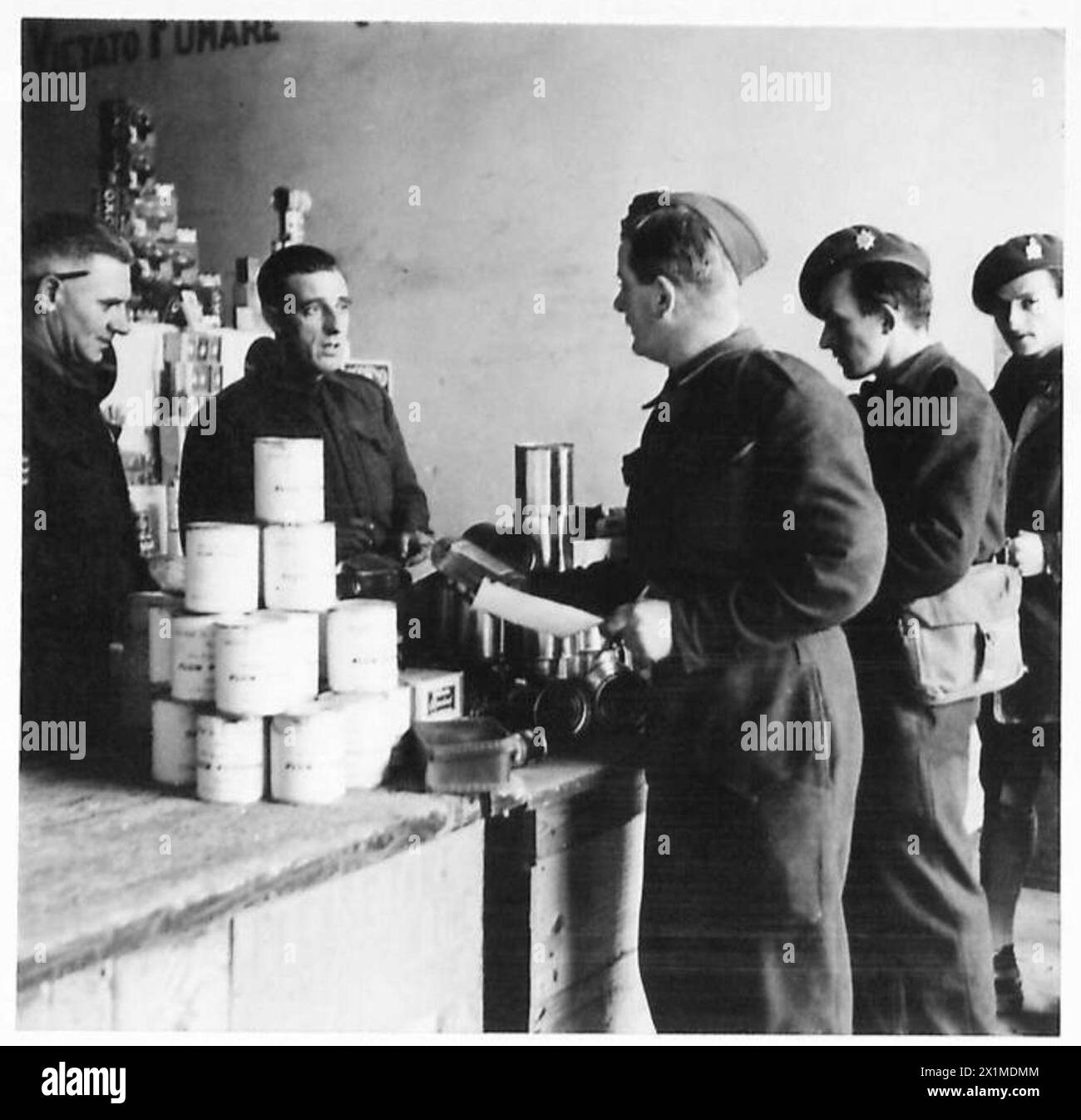 Eighth Army troops line up to receive their rations, including tinned turkey and Christmas pudding, during field operations. Stock Photo