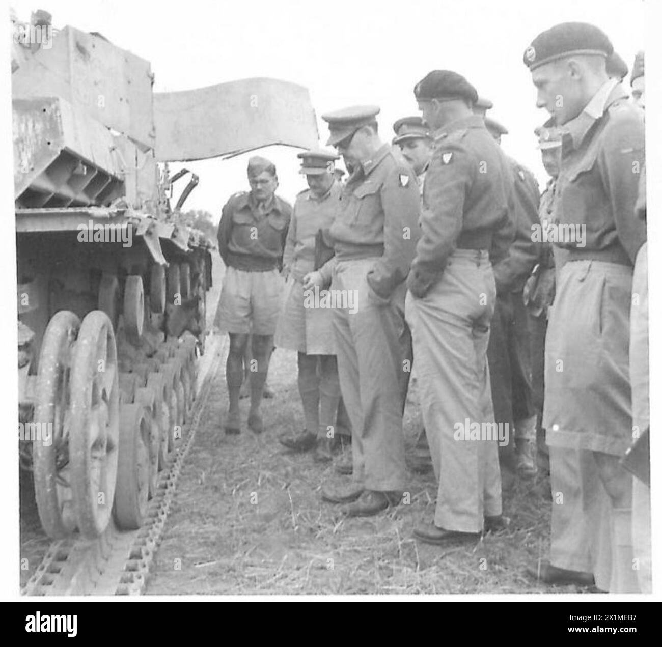 British Army officers examine damage at a site, documenting the extent ...