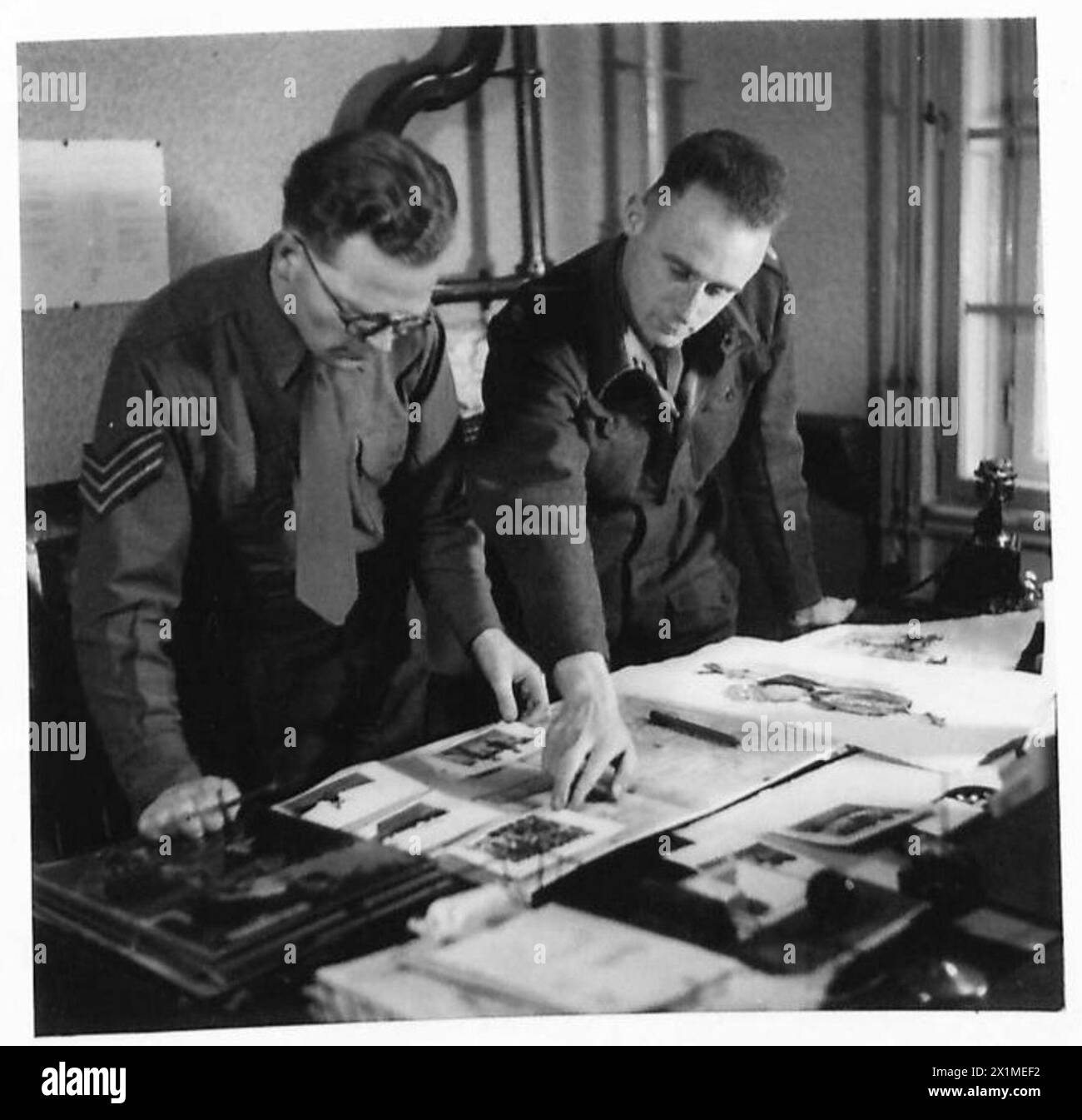 THE SOLDIER MAGAZINE IN HAMBURG - The edtior and the artist discuss the make-up of the proposed Highland Games feature page, British Army of the Rhine Stock Photo