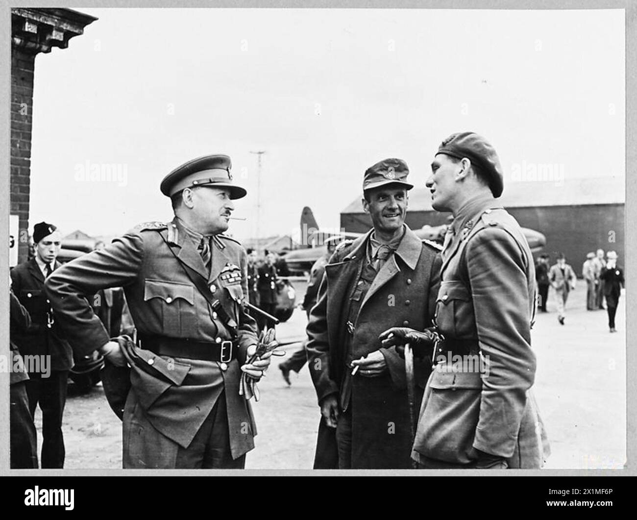 AXIS GENERALS ARRIVE IN SOUTH OF ENGLAND AS PRISONERS OF WAR. - 9958. Picture (issued 1943) shows - Colonel von Hulsen [centre] talking with escorting and receiving officers whilst awaiting transport to a prisoner of war camp, Royal Air Force Stock Photo