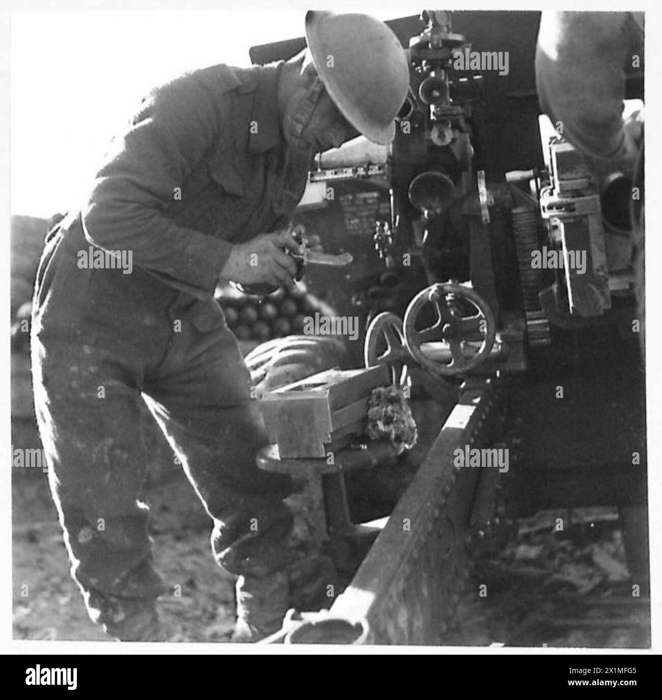 Eighth Army Inprocessing Gunner Thomas cleans the breech mechanism on a morning following a ...