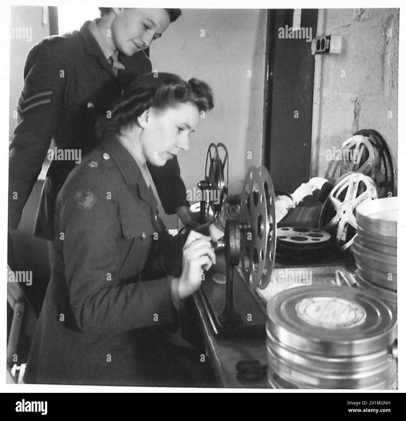 ATS projectionists repair film by winding it between spools over a ...