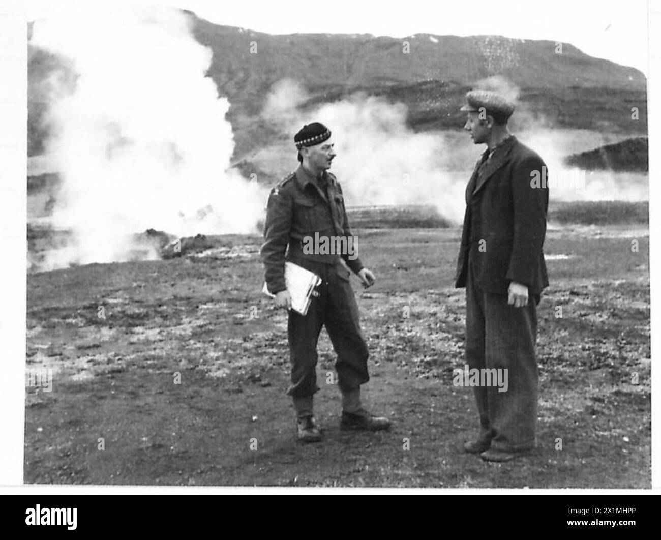 WITH THE BRITISH TROOPS IN ICELAND - A British Officer is seen chatting to an Icelandic hotel-keeper at Geysir where there is the greatest show of hot springs in Iceland, British Army Stock Photo
