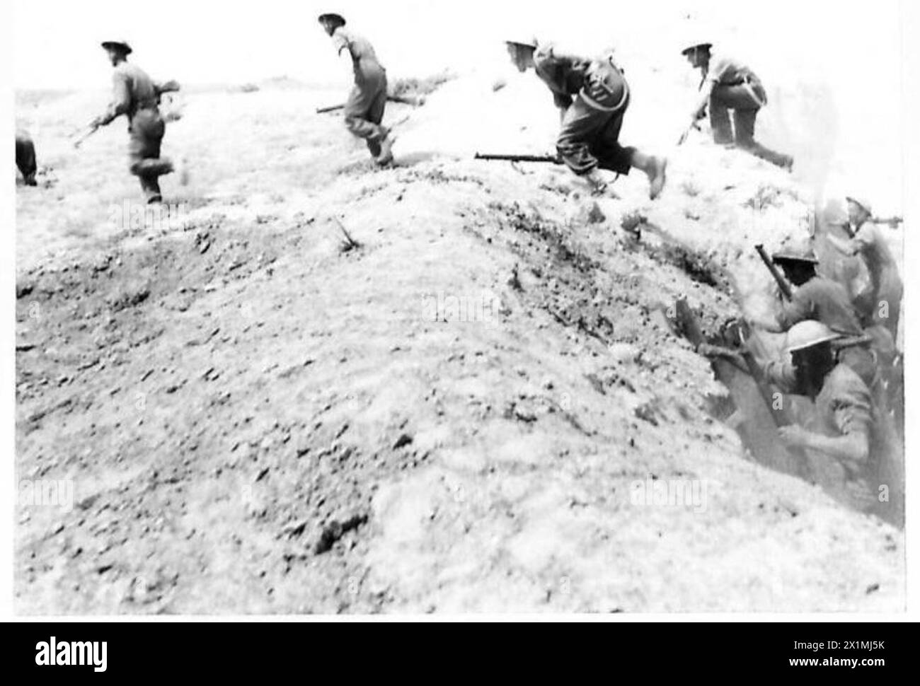 British troops practice using scaling ladders to climb the sides of Wadi Zigzoua, a major defensive feature of the Mareth Line, during Eighth Army training exercises. Stock Photo