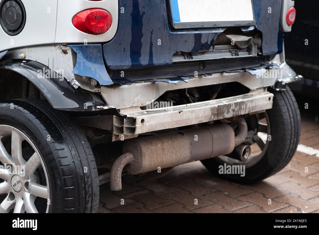 The damaged rear part of Smart car. accident consequences. broken bumper and a crumpled car body close-up Stock Photo