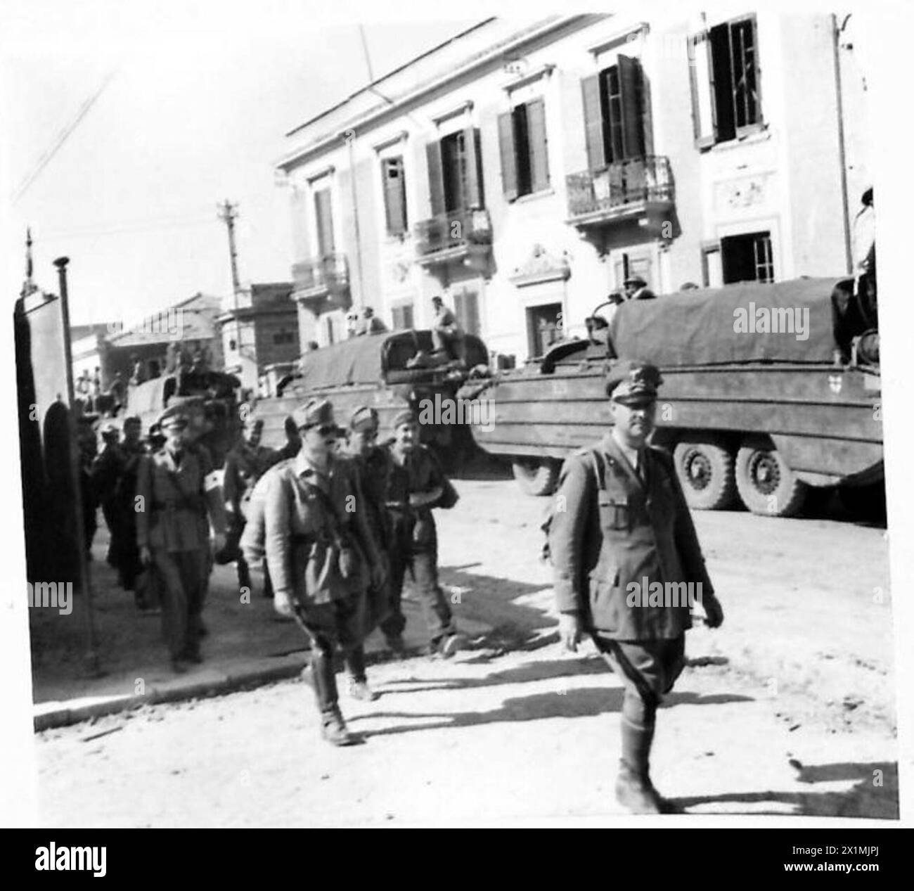 Italian prisoners of war captured by Canadian forces are marched ...