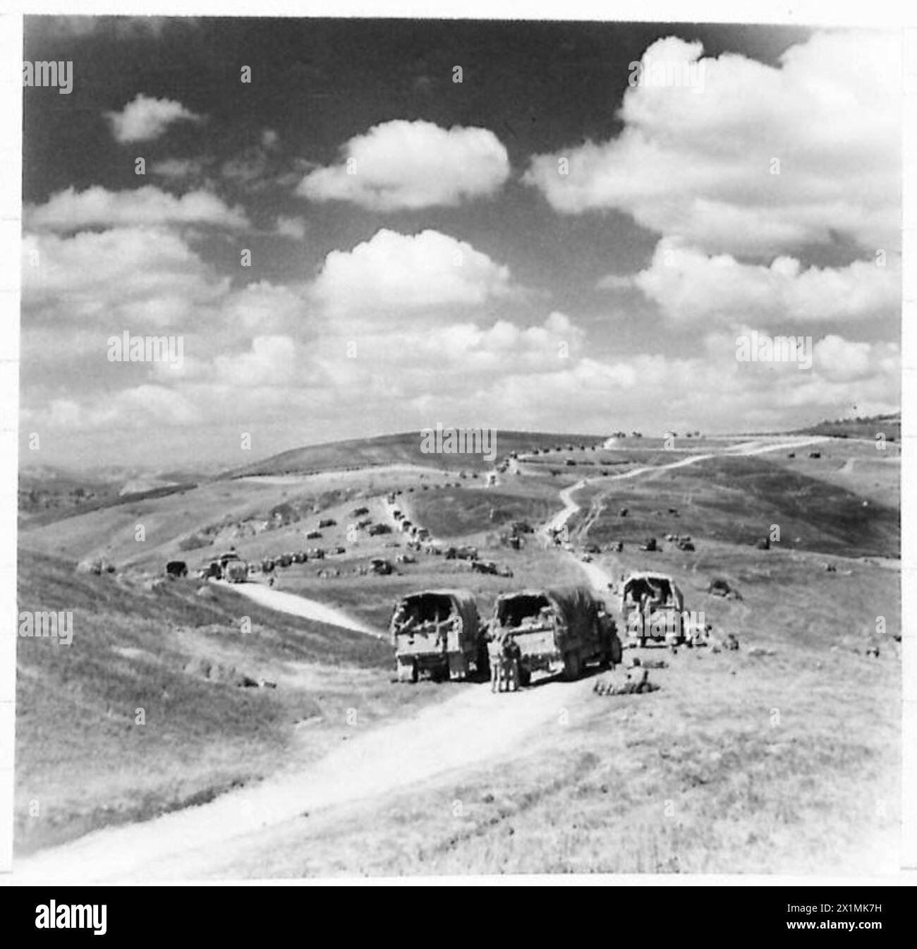 Eighth Army vehicle columns move over the hills of the Gothic Line as soldiers rest after completing tasks, British Army. Stock Photo