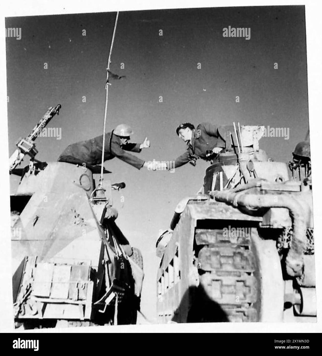 PICTURES FROM TOBRUK BEFORE THE BATTLE - Two tank commanders say 'Cheerio' before setting out, British Army Stock Photo