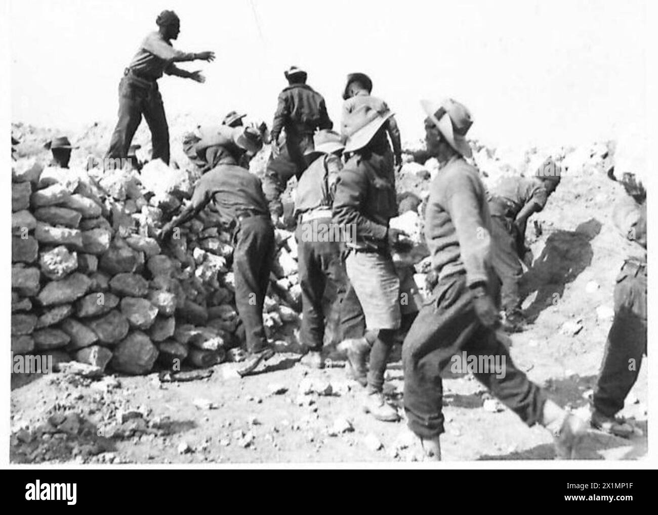 Coloured Sappers from the Cape demolish a roadblock by hand during the Eighth Army's attack on the Mareth Line. Stock Photo