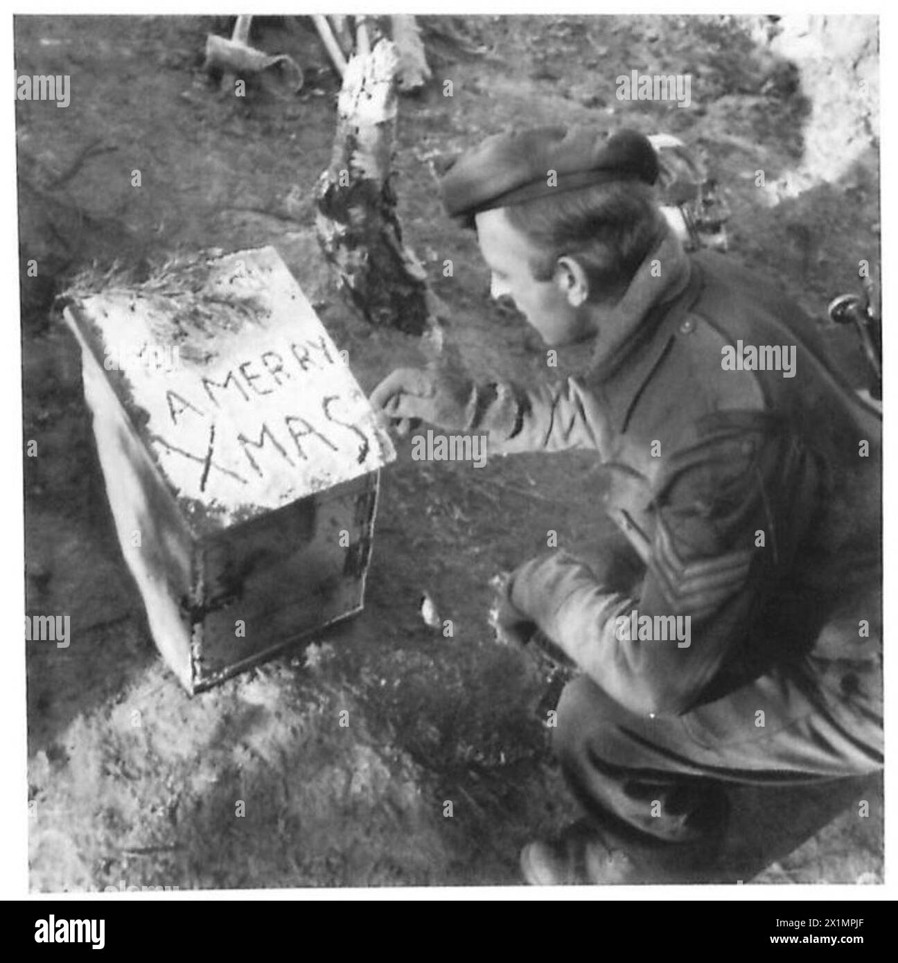 XMAS DAY IN GERMANY - Sgt. George Venn (Walworth) writes a greeting in the frost on the Post Box. RA , British Army, 21st Army Group Stock Photo
