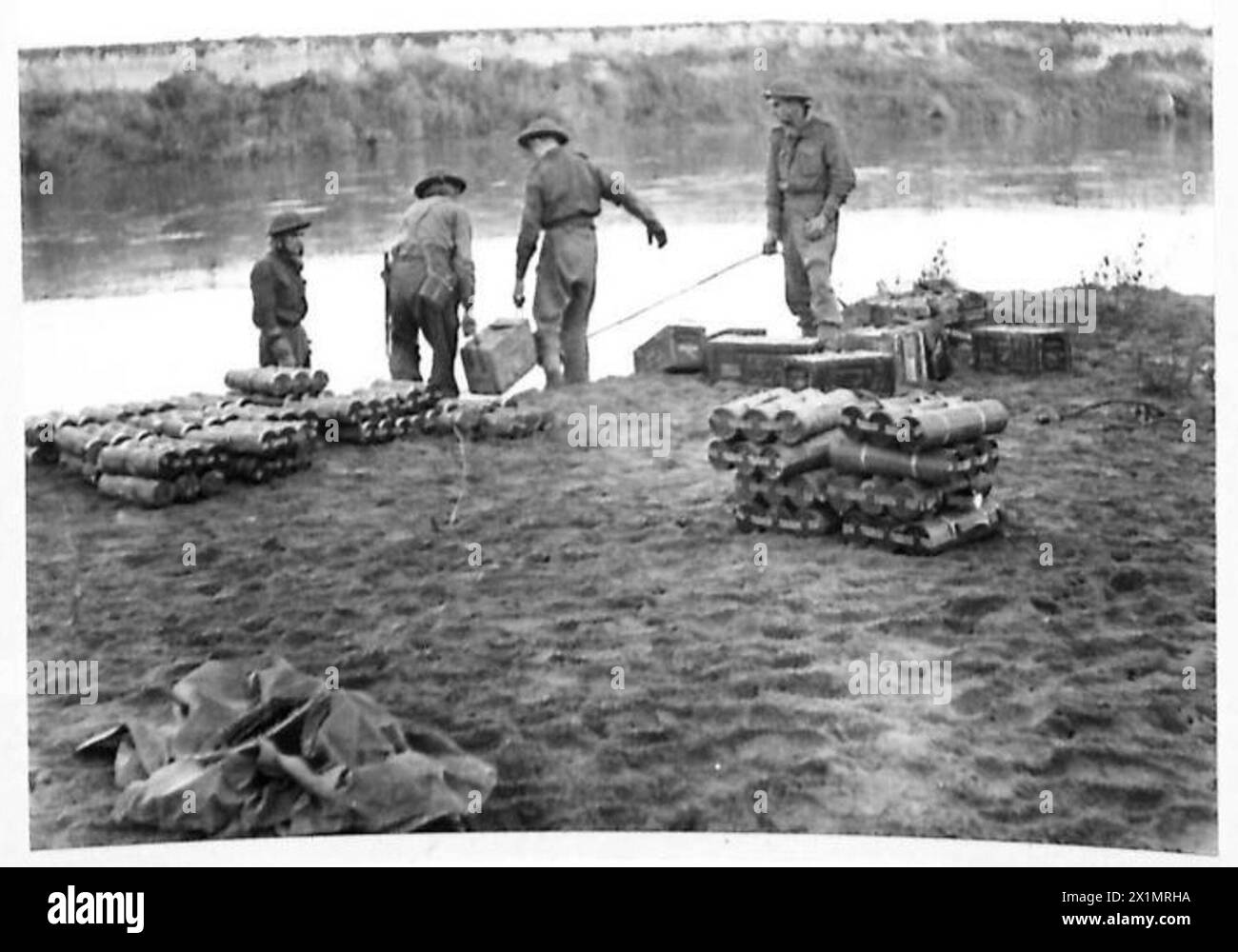 Fifth Army soldiers load ammunition onto an assault boat while crossing ...