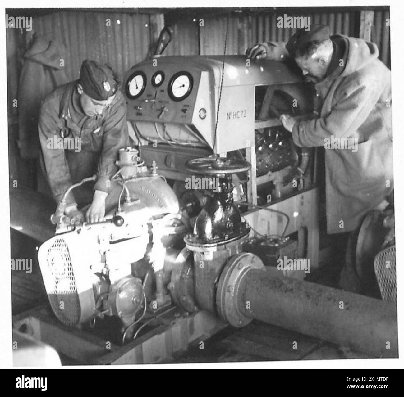 CLEARING OF MINES BY HIGH PRESSURE WATER JET - Low pressure pump in action from an inland water supply, British Army Stock Photo