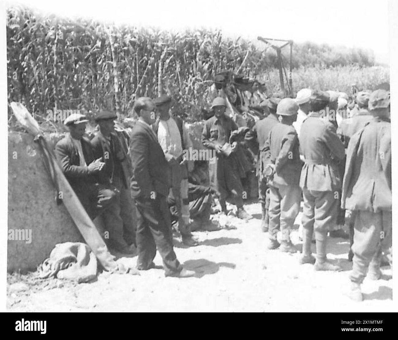 Prisoners are held on the beach awaiting transfer to landing craft during the invasion of Sicily, British Army. Stock Photo