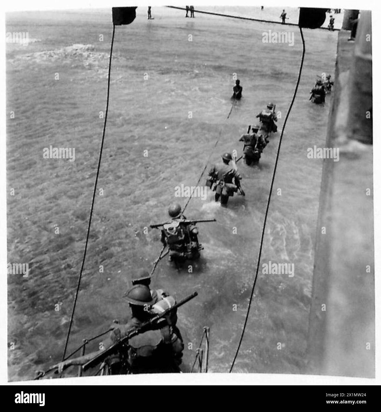 INVASION OF SICILY : FIRST PICTURES - Infantry wading ashore from landing craft, British Army Stock Photo