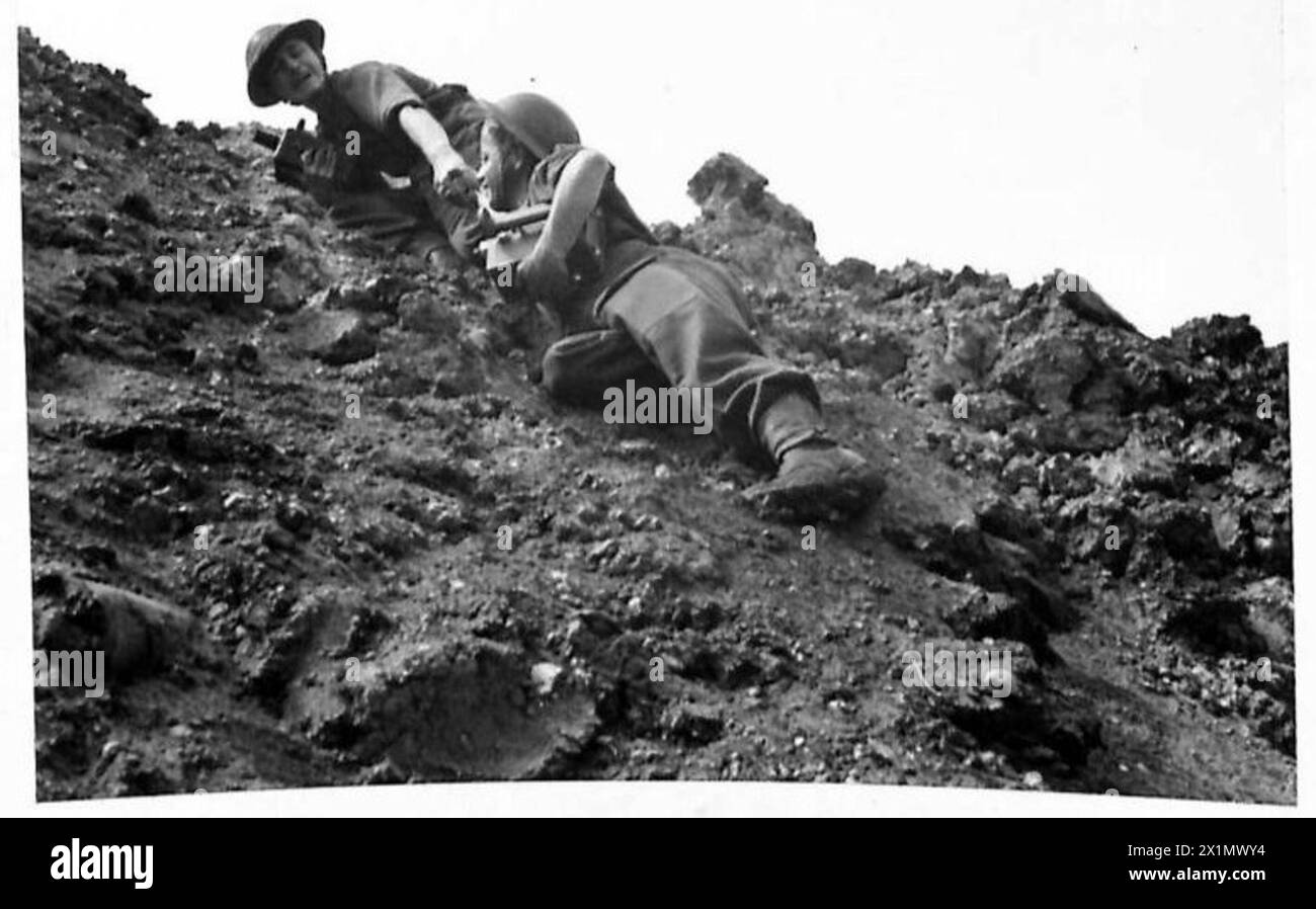 Army Film Unit cameramen assist each other during doubling up training ...