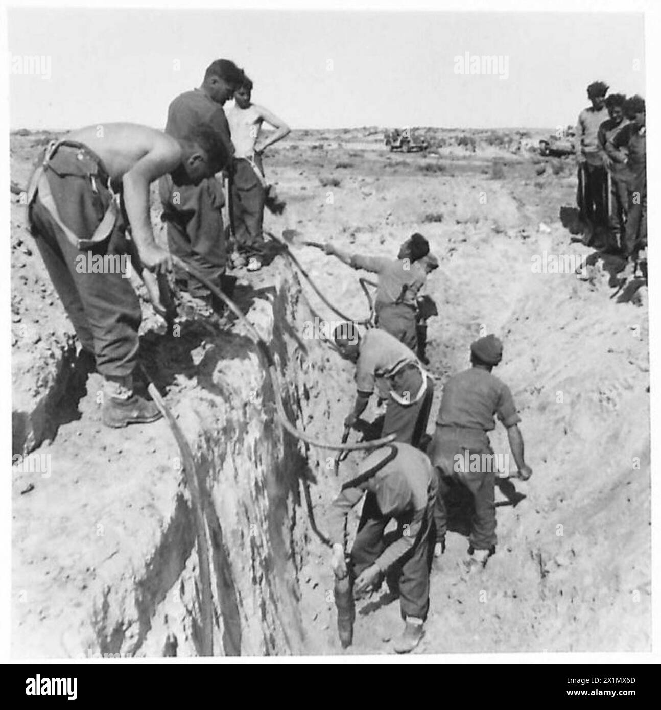 Seaforth Highlanders and Royal Engineers (Sappers) prepare defensive positions in front of the Mareth Line during Eighth Army operations, with 1,700 prisoners captured in the opening phases. Stock Photo