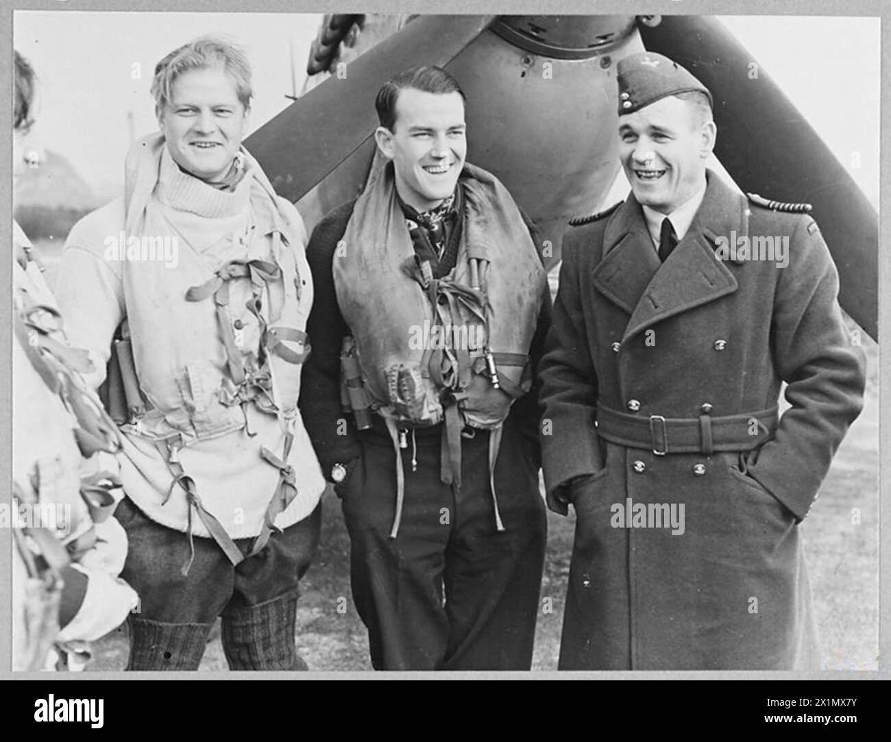 BRITAIN'S ACE FIGHTER PILOT TAKES OVER COMMANDOF A CRACK FIGHTER STATION - 8103 Group Captain A.C. Malan, with two of the fighter pilots before they took off on a daylight sweep. The pilot in the centre is S/Ldr. Hugo Armstrong, DFC., whose home is in West Perth, Australia, Royal Air Force Stock Photo