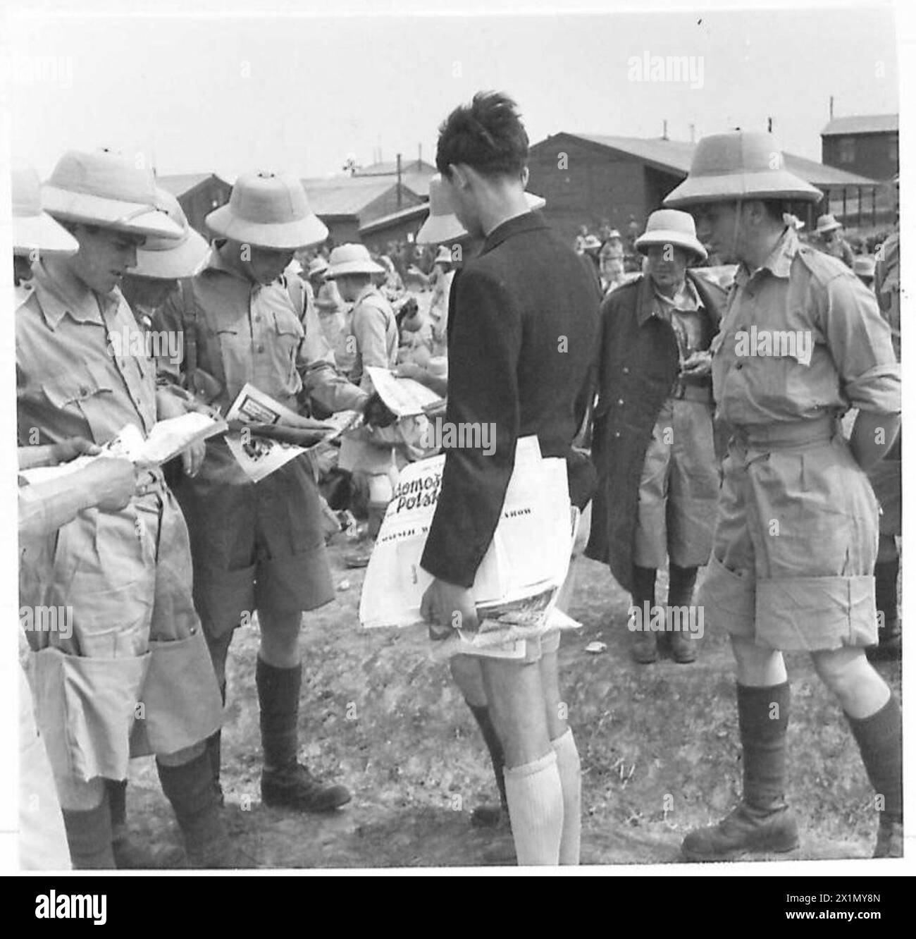 THE POLISH ARMY IN THE MIDDLE EAST, 1942-1943 - Newly arrived troops, already wearing tropical uniforms, eagerly buying a Polish newspaper 'Polskie Wiadomości - Polish News', published in Palestine. After the Soviet invasion of Poland in September 1939 large numbers of Polish troops were rounded up and imprisoned in various Gulag camps by the Russians along with enormous number of civilians. Following German invasion of Soviet Union and the Sikorski-Mayski Agreement, these Poles were released.On 3 May 1942 various units of the Polish Army in the Soviet Union (mainly 9th and 10th Infantry Divis Stock Photo