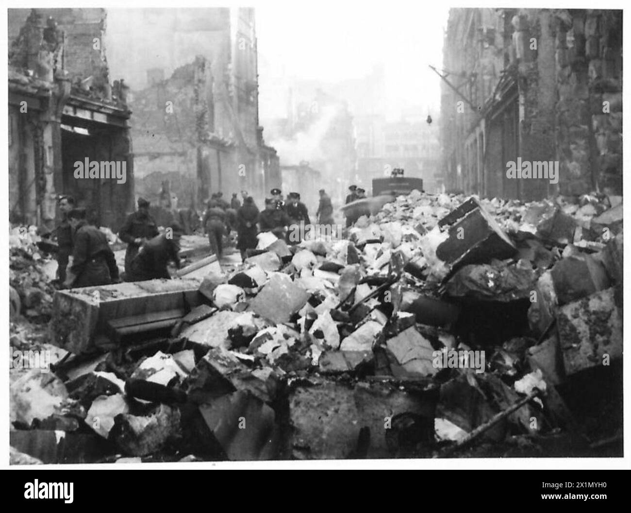 CLEARING UP LONDON DEBRIS Men of the A.M.P.C. working in conjunction with the R.Es are