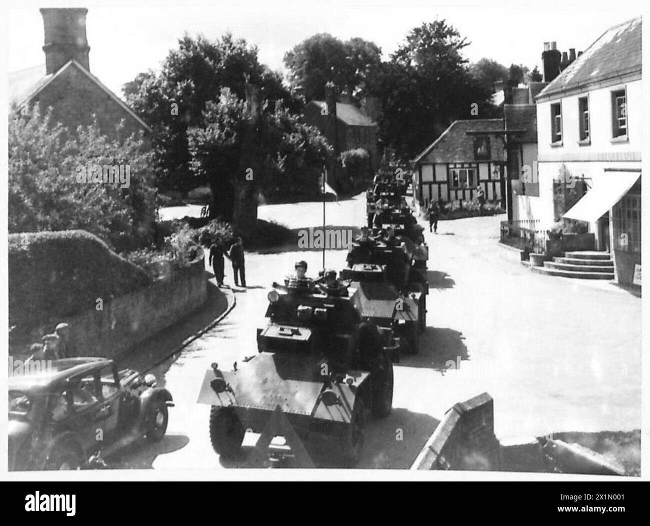 Scouting Tank Scout tanks moving through Shere, a well-known Surrey location, during ...