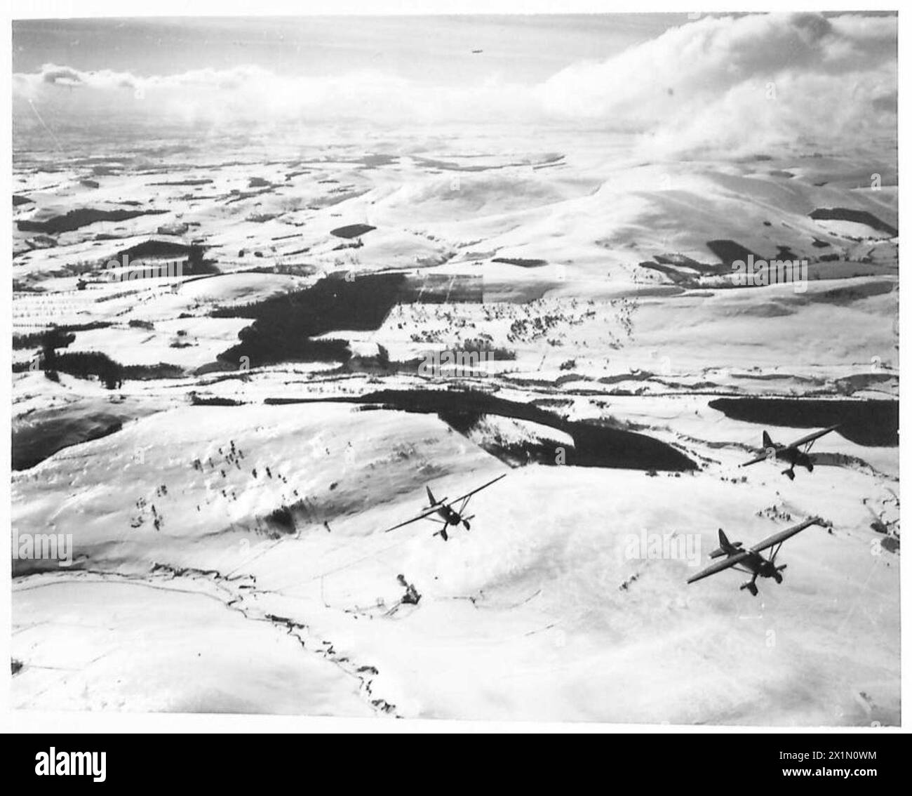 THE POLISH AIR FORCE IN BRITAIN, 1940-1947 - Three Westland Lysander Mark IIIAs of No. 309 Polish Fighter-Reconnaissance Squadron (part of the RAF Army Cooperation Command), based at Dunino, Fife, on a photo reconnaissance training sortie over snow-covered Scottish hills, Polish Air Force, Polish Air Force, 309 'Land of Czerwień' Fighter-Reconnaissance Squadron, Royal Air Force, Station, Calveley Stock Photo