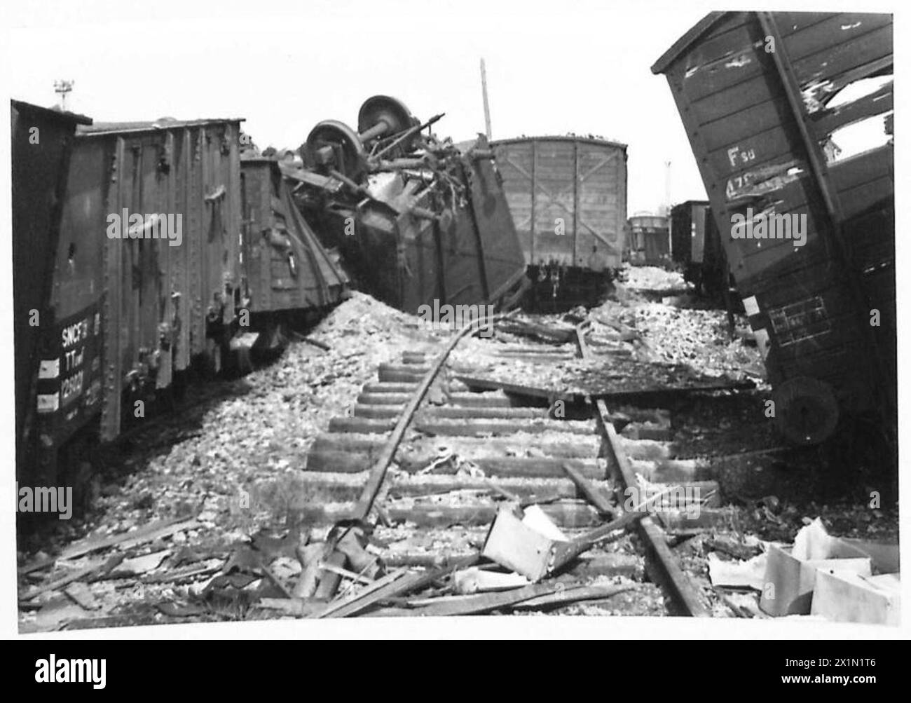 REPAIRING BOMB DAMAGE AT CAEN RAILWAY CENTRE - Damage to the goods wagons and permanent way in the goods yards, British Army, 21st Army Group Stock Photo