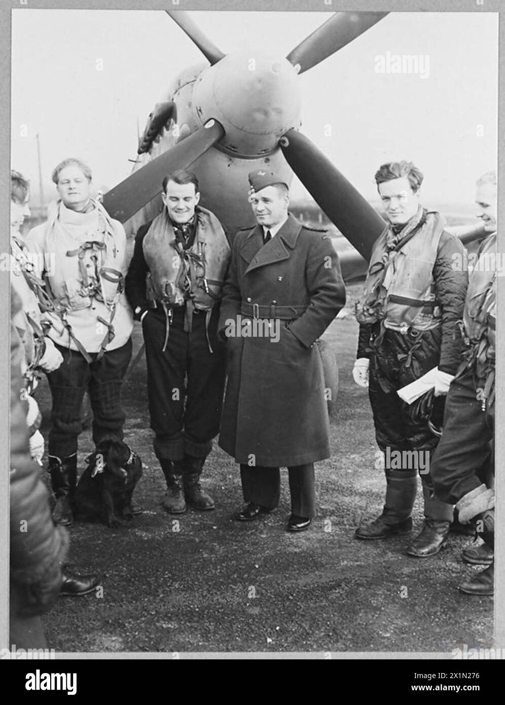 BRITAIN'S ACE FIGHTER PILOT TAKES OVER COMMANDOF A CRACK FIGHTER STATION - 8103 Group Captain A.G. Malan talking to some of the fighter pilots before they took off on a daylight sweep, on the first day of his command, Royal Air Force Stock Photo