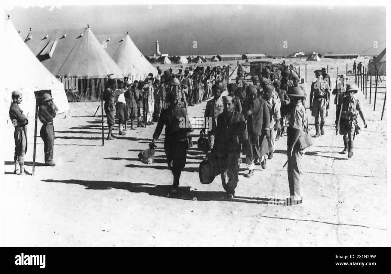 An Italian prisoner of war is shown being marched away by British Army ...
