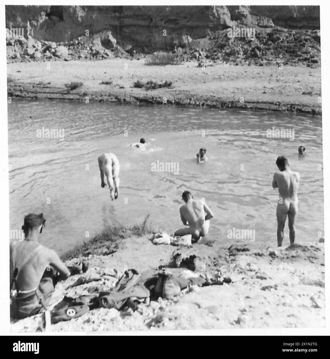 Seaforth Highlanders of the British Eighth Army swim in the flooded Wadi Zessar near the Mareth line after participating in a crossing operation during the battle. Stock Photo