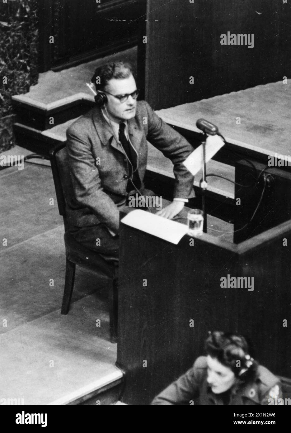 SS MAJOR GIVES EVIDENCE AGAINST KALTENBRUNNER AT NUREMBERG WAR CRIMES TRIALS - SS Major Dieter Wisliceny, described as a Gestapo specialist in Jewish problems giving evidence on 3 January 1946 at Nuremberg. Here he sits in the witness box giving evidence against Ernst Kaltenbrunner, head of Himmler's secret police, Stock Photo