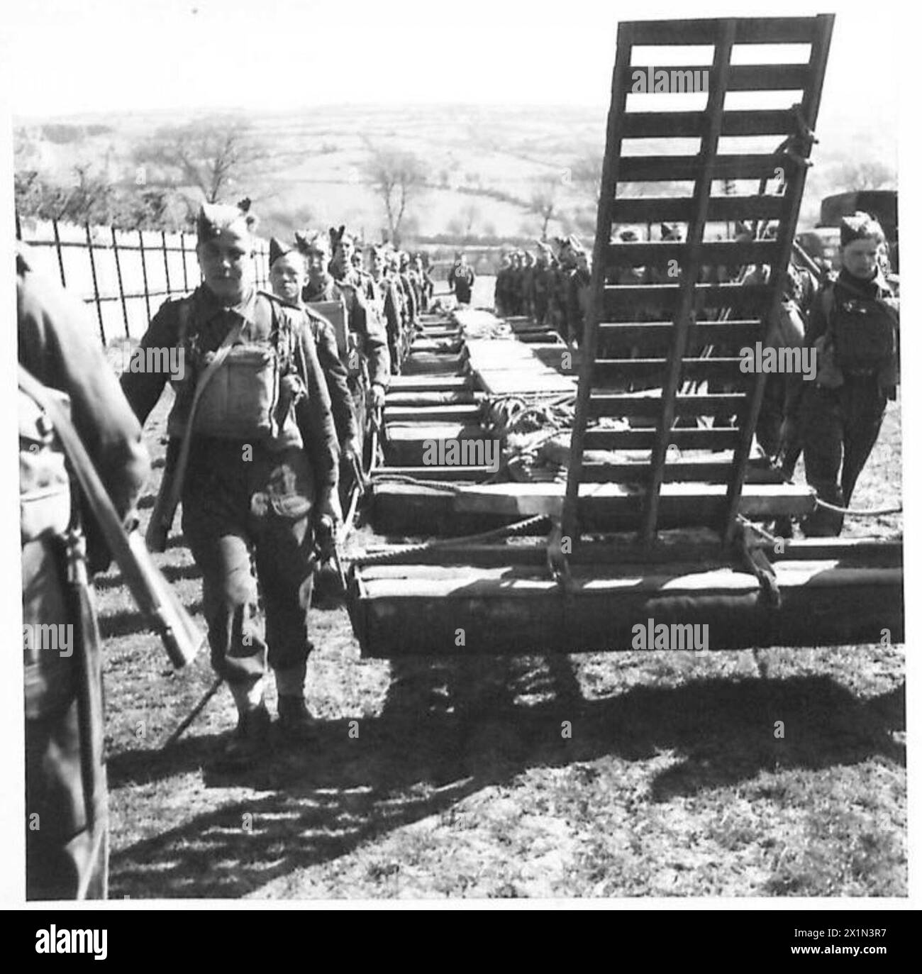 Infantrymen practice bridging techniques by carrying a bridge to the ...