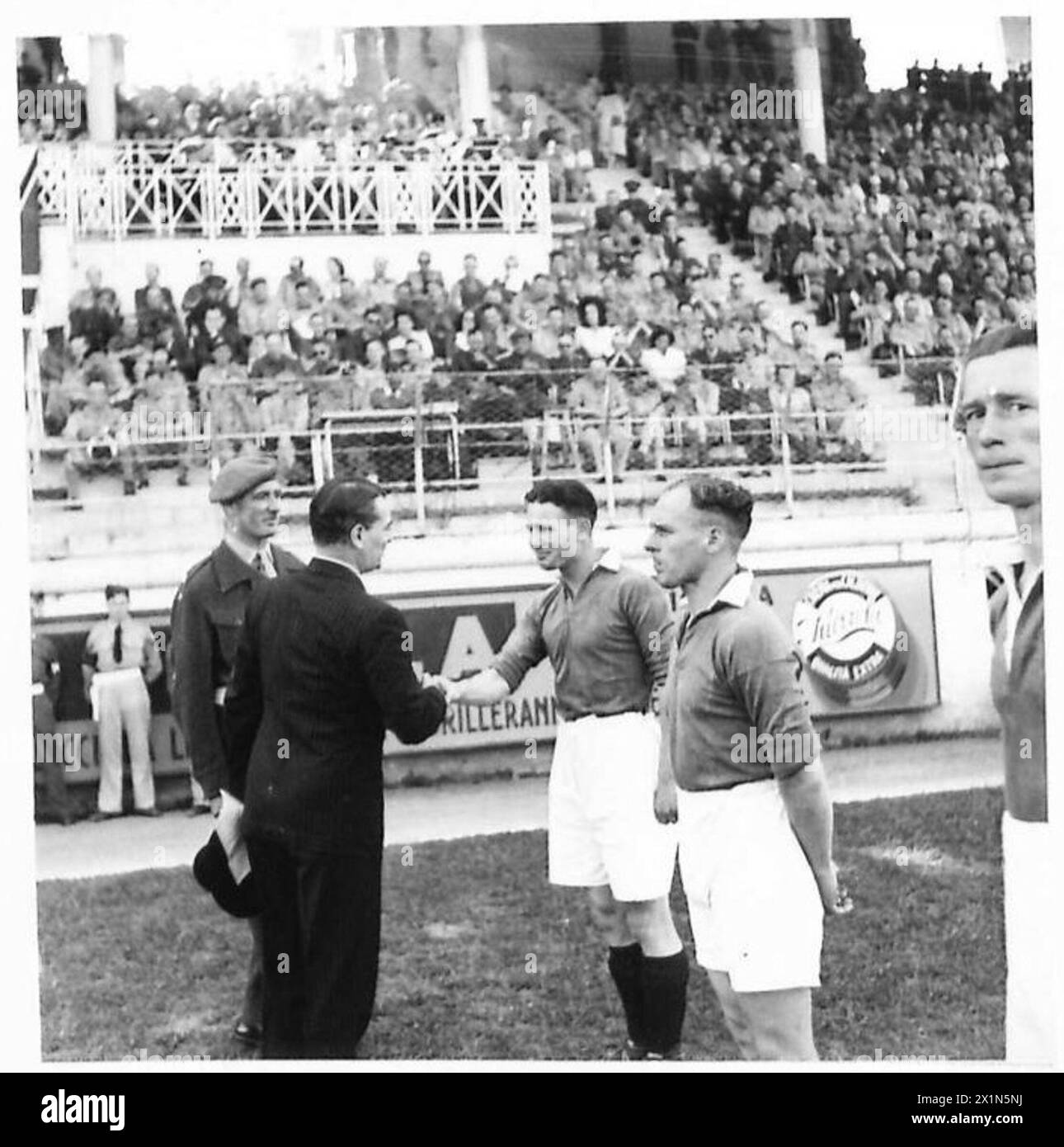 WEEK-END SPORT IN C.M.F. - Sir Noel Charles shakes hands with Sgt. Packard (Sheffield Wednesday) Captain of the C.M.F. eleven, British Army Stock Photo