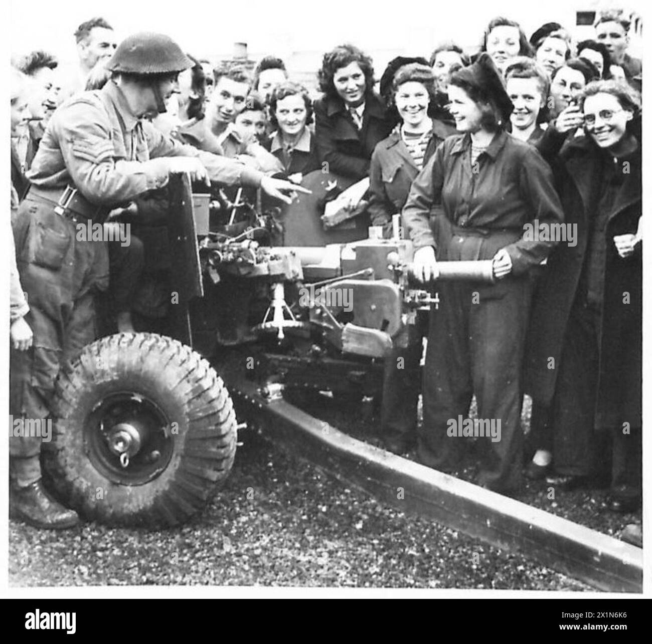 A Royal Artillery sergeant explains anti-tank gun loading procedures to ...