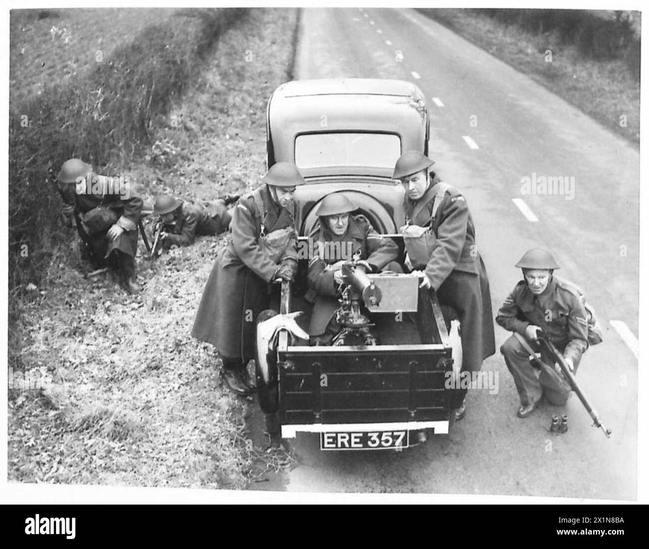 Home Guard members conduct a military exercise using a Browning machine ...
