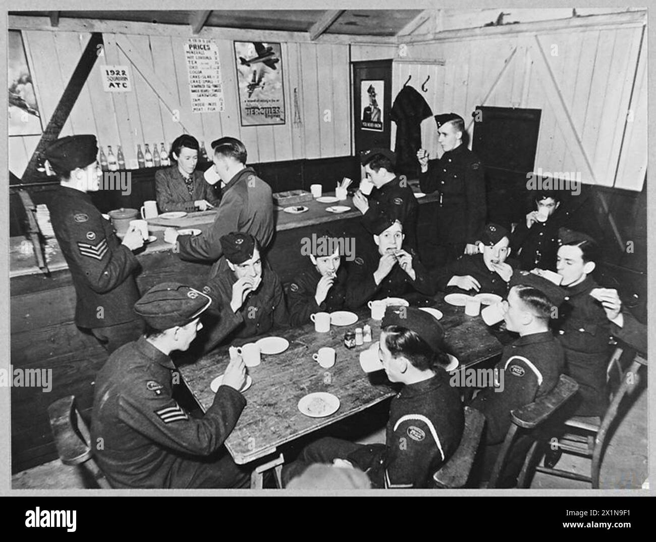 NO.1922 [5TH CITY OF BRISTOL] SQUADRON A.T.C. - Picture (issued 1944) shows - Cadets of No.1922 ATC Squadron tuck in to a hearty tea in the canteen they have built from packing bases, Royal Air Force Stock Photo